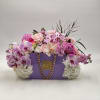 This luxurious garden-inspired arrangement features seasonal blooms beautifully styled in a signature