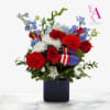 Celebrate Independence Day with this festive arrangement featuring radiant red roses and