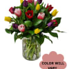 Mixed tulip bouquet in a clear glass vase with a color-will-vary note