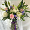 Soft pale pink roses and creamy white hydrangeas meet vivid purple irises