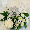 A paw-print memorial stone reading "Forever in our Hearts" sits at the