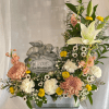 Soft white lilies take center stage in this pet farewell arrangement, a