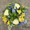Bouquet of white roses, yellow alstroemeria, and blue flowers