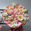 Pink and peach bouquet with roses, gerbera daisies, and lily buds