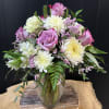 Beautiful mix of purple and white flowers including roses, cremons, alstromeria, etc.
