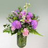 Purple and pink flowers in a mason jar style vase