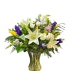 Large, garden-style bouquet of tulips, white lilies and roses with purple, yellow