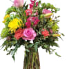 Full, garden-style mix of pink and yellow roses, yellow cremons, orange carnations