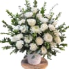 All white sympathy arrangement with roses, cremons, and carnations
