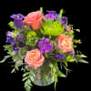 Pink, purple, and green flowers in a mosaic vase.