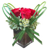 Fun, modern arrangement of roses with lily grass, waxflower and greens