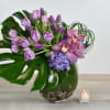 This Violet floral design comes in a glass vase, with purple tulips