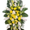 Standing floral spray with yellow roses, white chrysanthemums, and white gladiolus