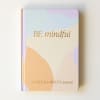 Pastel journal with the words "BE mindful" on the cover