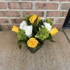 Yellow roses and white carnations in a glass vase