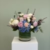Lunelle is an elegant and romantic floral arrangement featuring lush blue hydrangeas