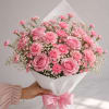 A soft spray of pink roses and clustered carnations makes this blush-toned