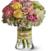 A rounded cluster of pink, yellow and blush roses mingles with cheerful