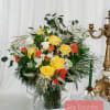 Yellow and orange rose arrangement in a glass vase