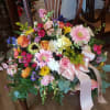 Large mixed bouquet with pink roses, gerbera daisies, and a pale ribbon