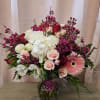 Mixed bouquet of pink and white flowers in a glass vase