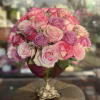 Pink and lavender rose bouquet in a gold pedestal vase