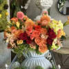 Colorful mixed flower arrangement in a white vase