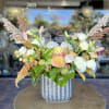 Mixed bouquet in a blue ceramic vase with white and peach blooms