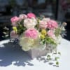 Pink and white roses with hydrangeas in a pale pink box