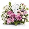 Pink and white floral arrangement with angel figurine centerpiece