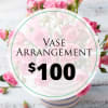 Pink rose arrangement in a striped vase with a price label overlay