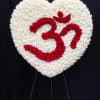 Heart-shaped floral tribute of white and red flowers on a stand