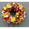 Colorful floral wreath with yellow lilies and red blooms