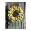Yellow and white floral wreath on an easel
