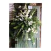 Tall white floral standing spray on an easel