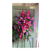 Tall pink and purple floral standing spray on an easel