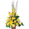 Tall yellow floral arrangement in a brown basket with branches