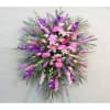 Large pink and purple standing floral spray with lilies and carnations