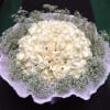 Round bouquet of white roses with baby's breath