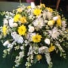 Yellow and white floral spray with mixed blooms and white calla lilies
