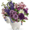 Bouquet of purple and pink flowers in a unicorn-shaped vase
