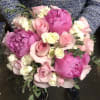 Bouquet of pink peonies, roses, and white mini roses with greenery