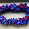 Oval floral wreath of blue-purple orchids and red roses