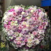 Large heart-shaped floral arrangement with pink, white, and lavender blooms