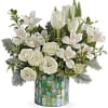 White tulips and roses arranged in a mosaic vase