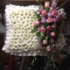 Standing floral tribute with white daisies and pink roses