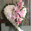 Heart-shaped funeral wreath with pink lilies, roses, and white flowers
