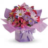 Compact bouquet of pink and lavender flowers in a lavender gift box with matching ribbon