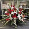 Large red and white floral spray with lilies, roses, and daisies