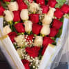 Bouquet of red and white roses with baby's breath in clear wrap